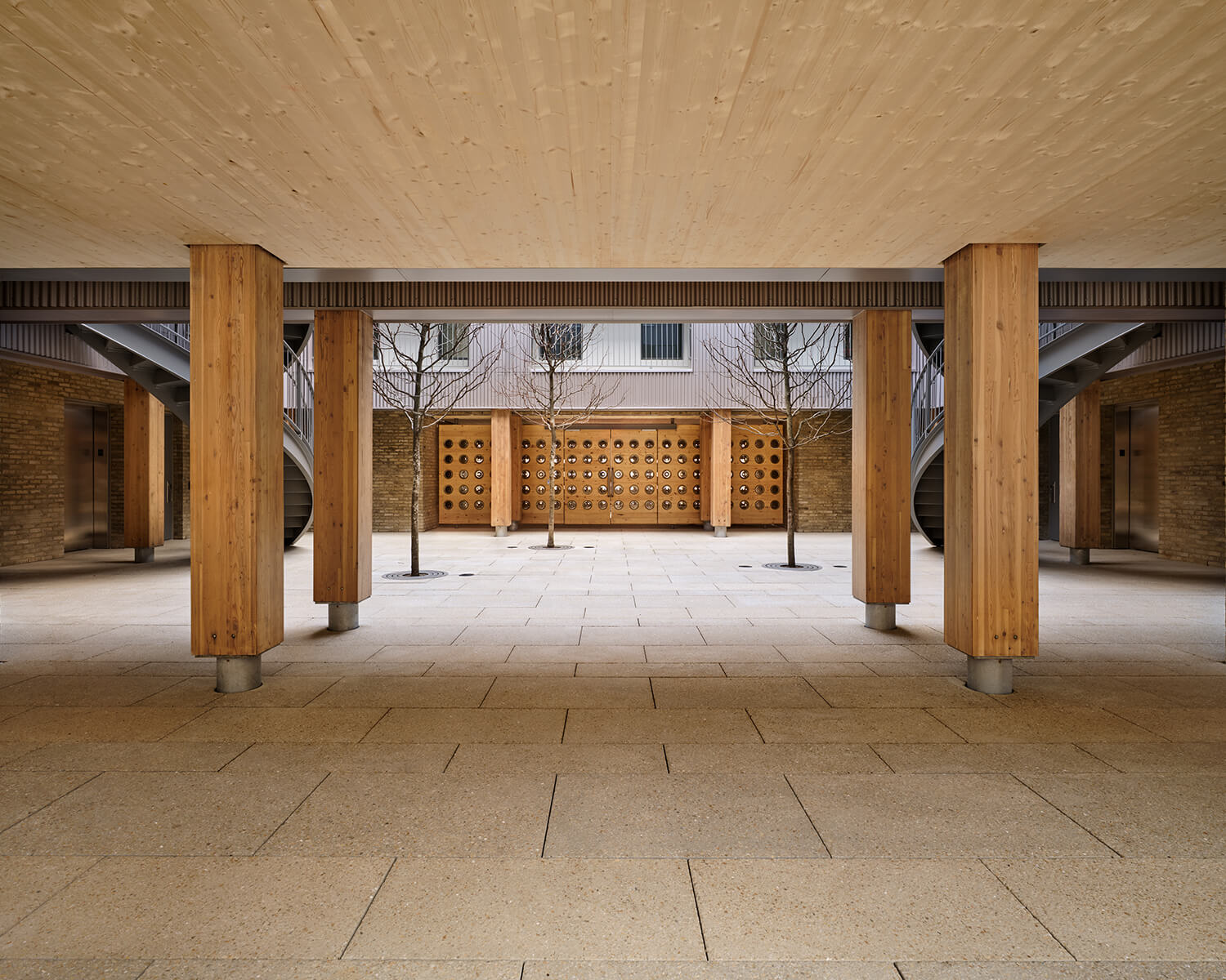 Covered entrance to courtyard showing mass timber roof and columns