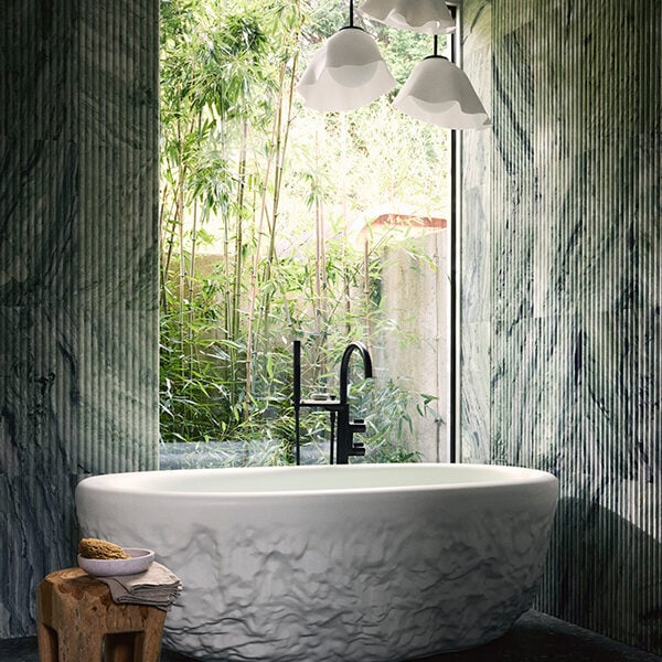 Reminiscent of Daniel Arsham’s eroded sculptures, the freestanding bathtub appears to be hand-carved from a block of stone; in actuality, it is made from the brand’s durable Lithocast cast-resin material.