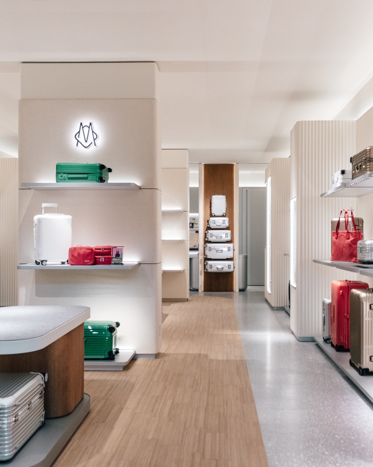 The interior of Rimowa's new store at Yorkdale mall in Toronto, showing suitcases on shelving.