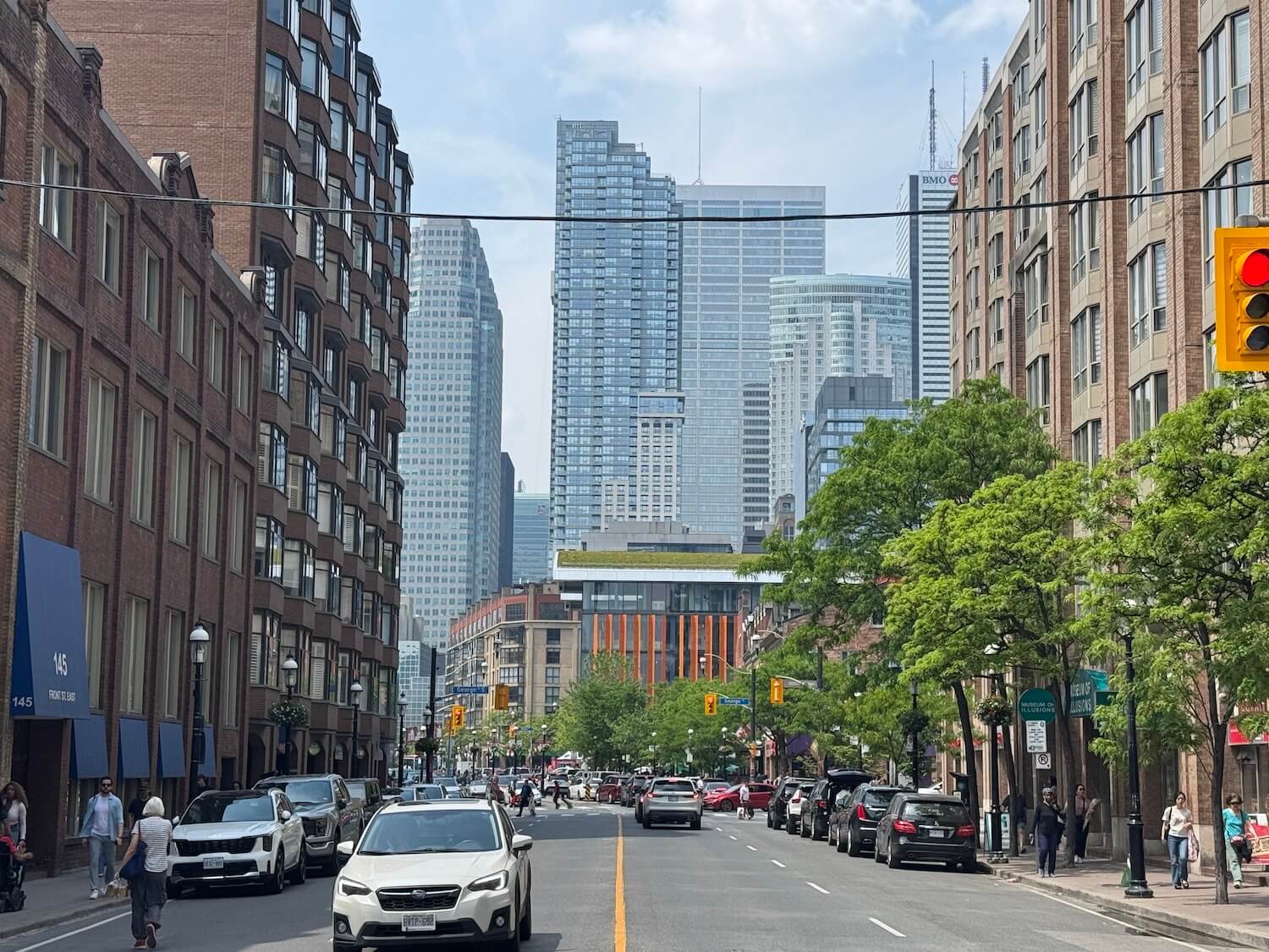 Looking west from Front Street, with St. Lawrence market prominently visible against the blue-glass skyline.