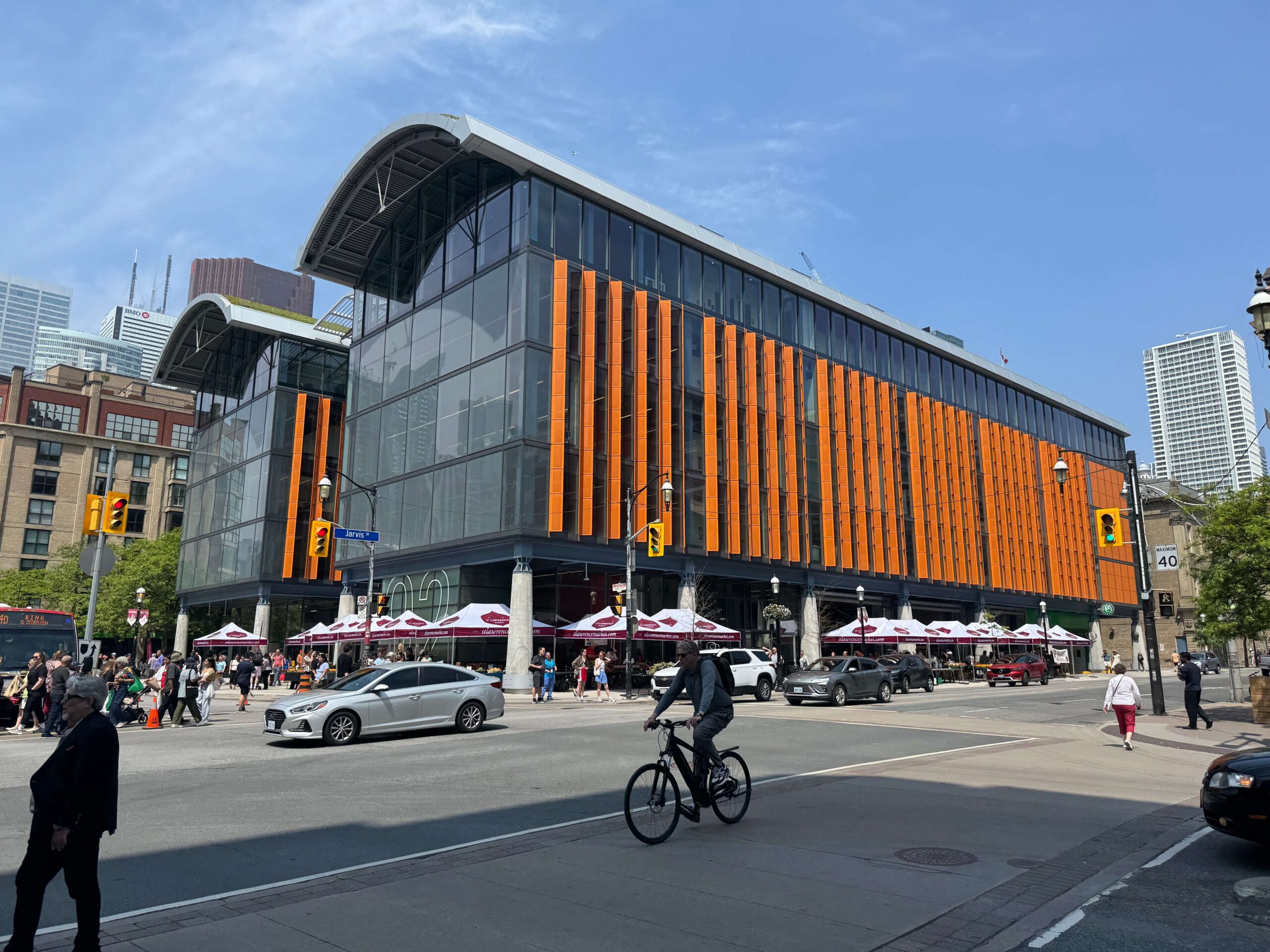 The market's curved roofs and orange solar fins make it an instantly recognizable presence on the streetscape.