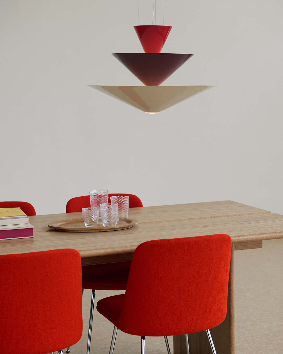 Table with red chairs and hanging lamp
