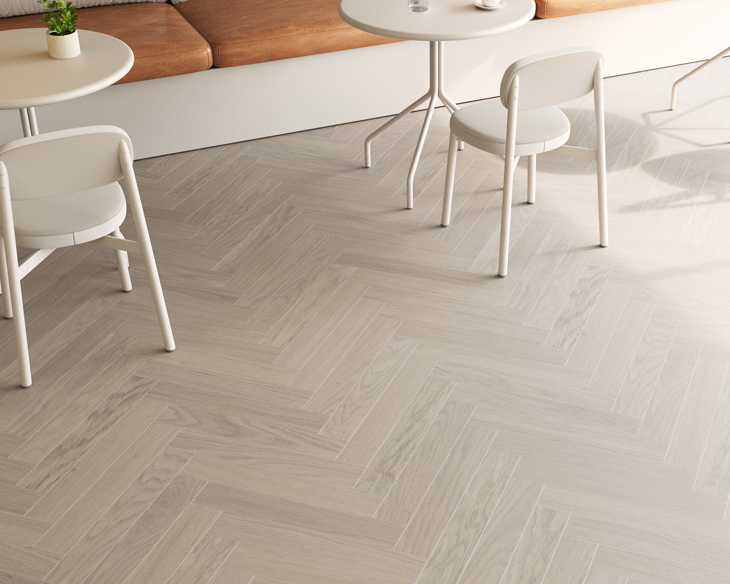 Light gray Woodura Herringbone 2.0 by Bjelin under two sets of white tables and chairs