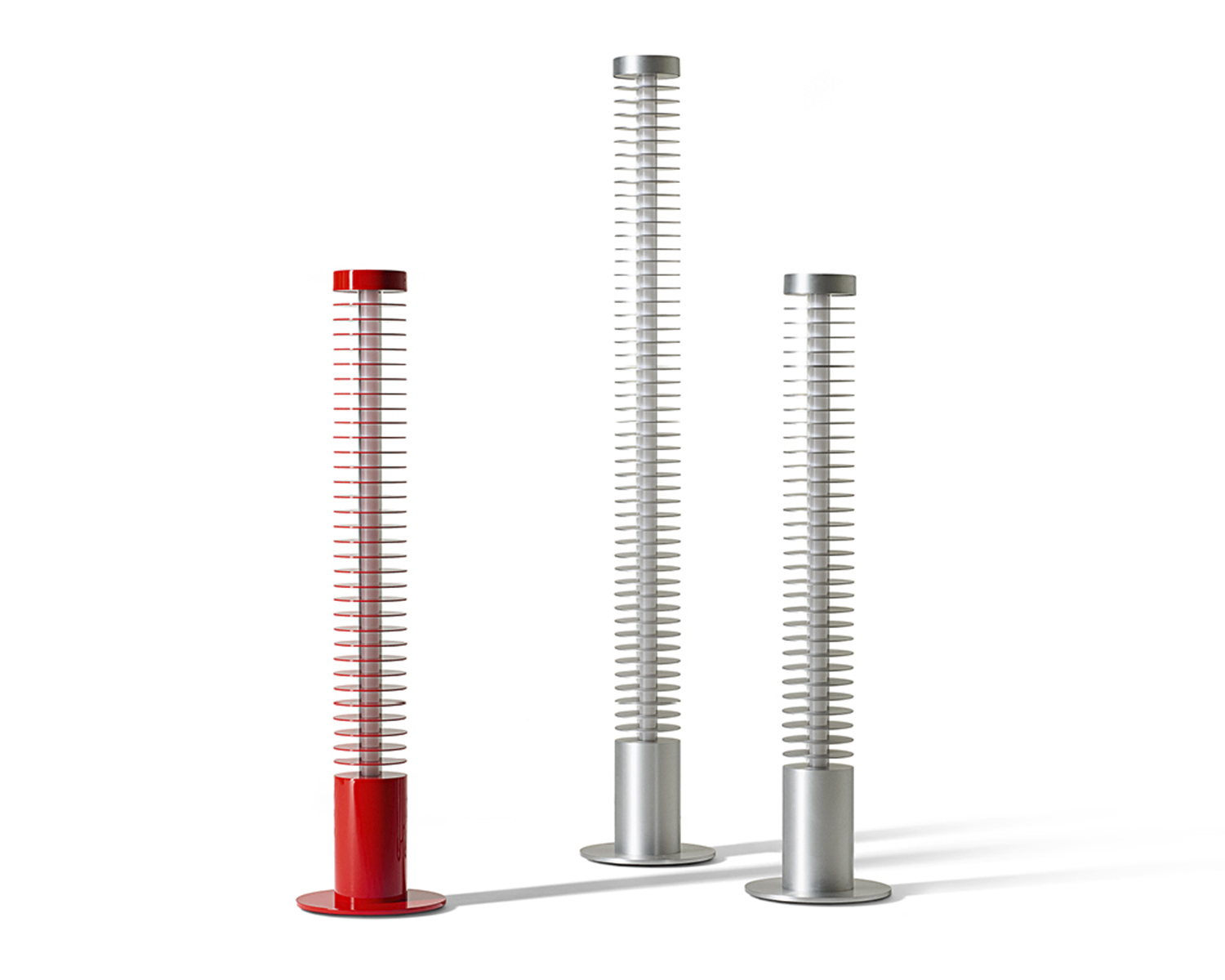 Three Iride floor lamps (1 red and 2 silver) by Cassina in a white room