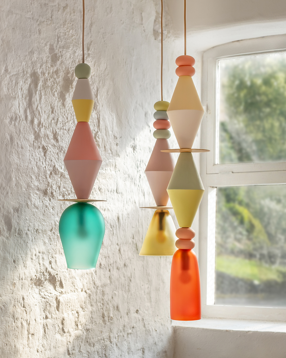 Window lighting shining on three multicoloured lamps from Carnival collection by Curiousa