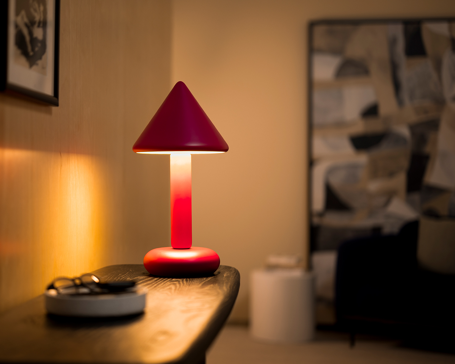 Dimly lit room with red table light on a side table