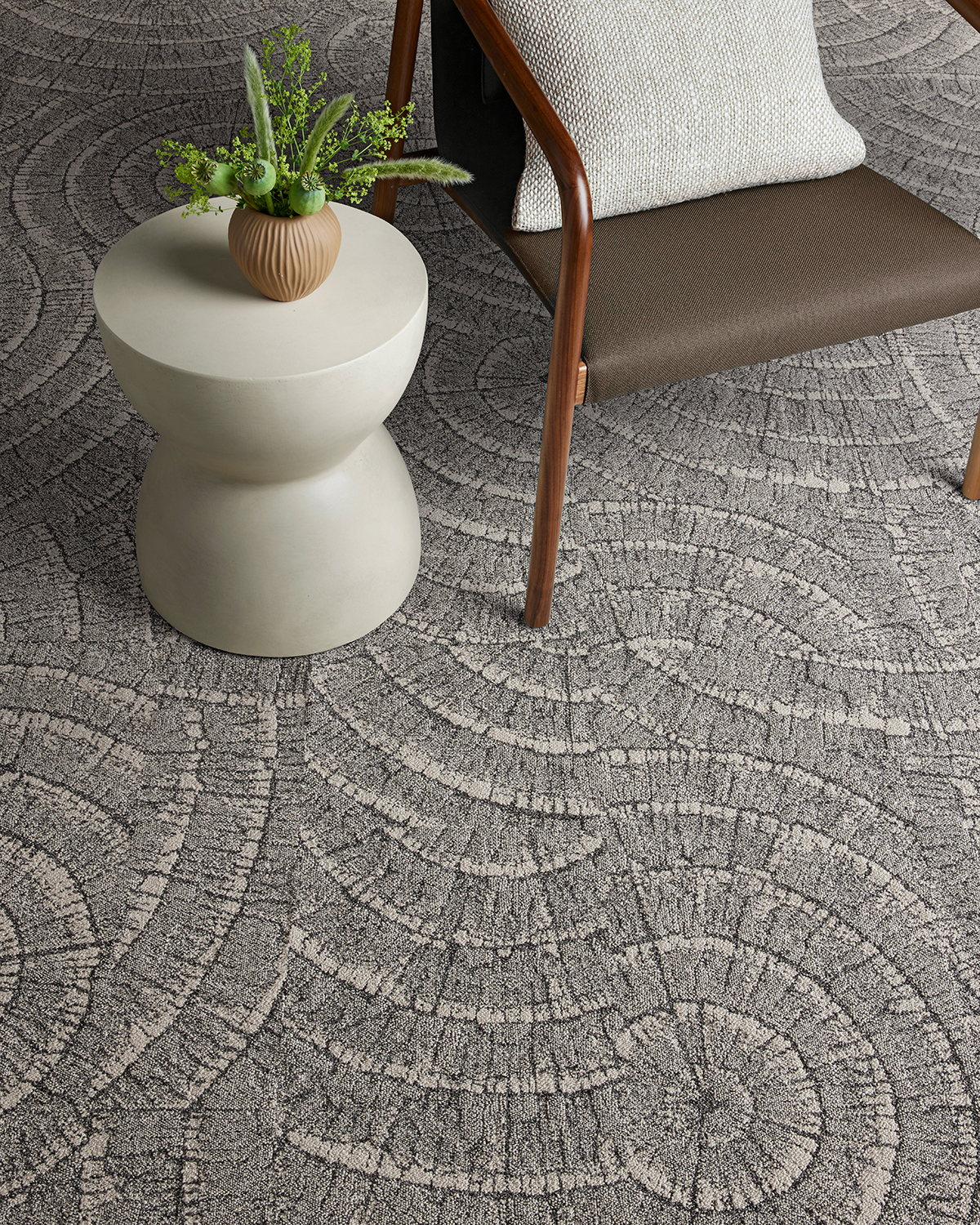 Gray chair and side table on gray Etched Earth carpeting by Interface