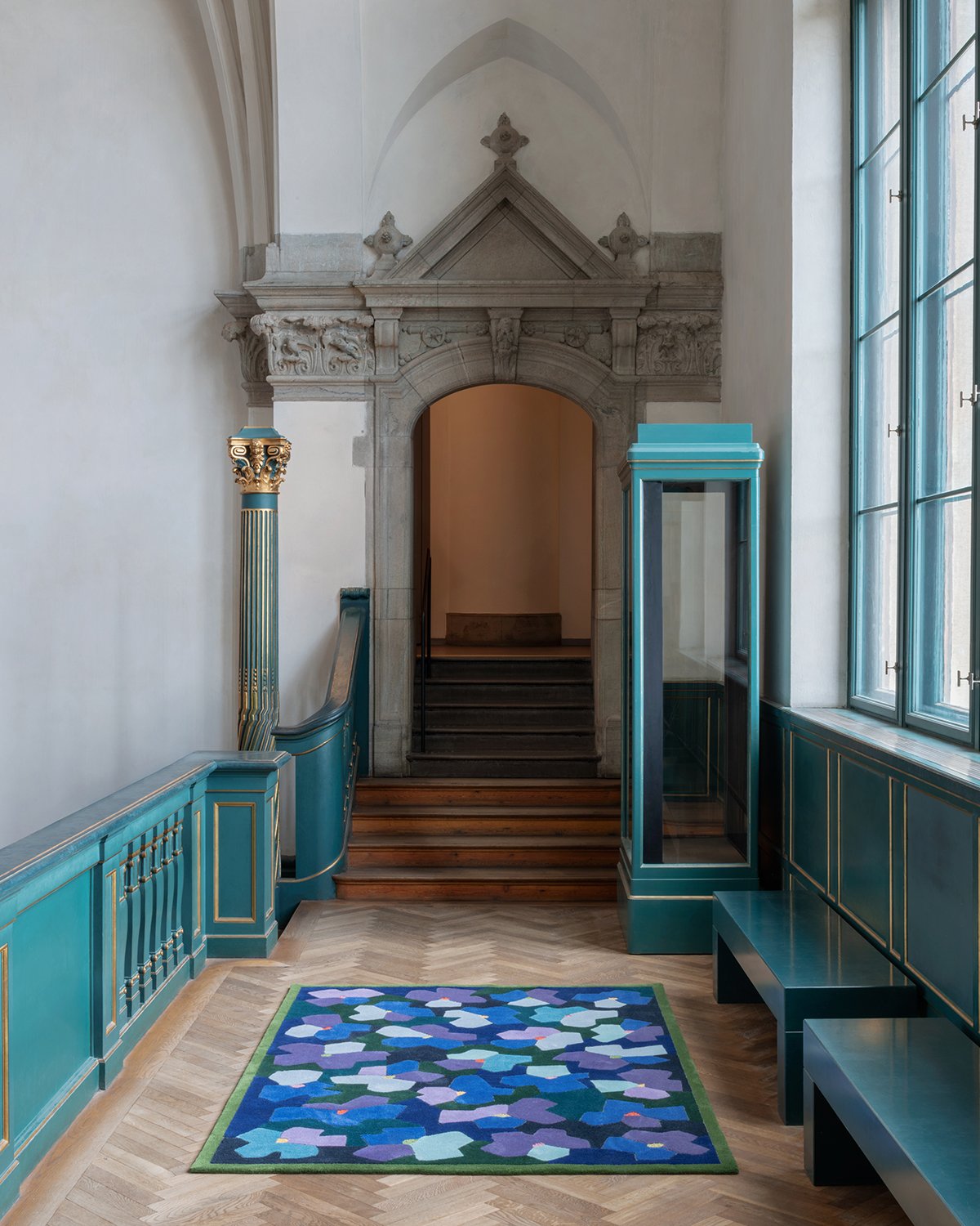 Blue, purple and light blue floral pattern–Anemon by Kasthall displayed in front of an indoor doorway