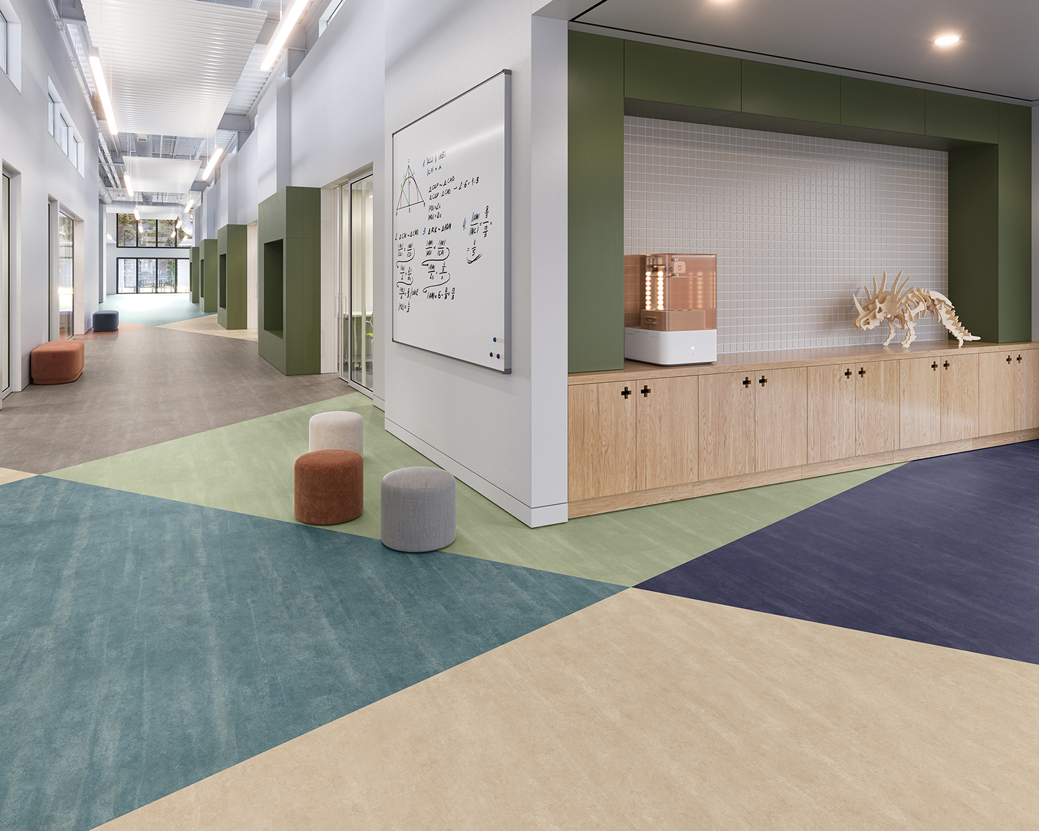 Chromascope 2.5 by Mohawk Group in tan, teal and dark blue tile flooring with white walls and scattered ottomans