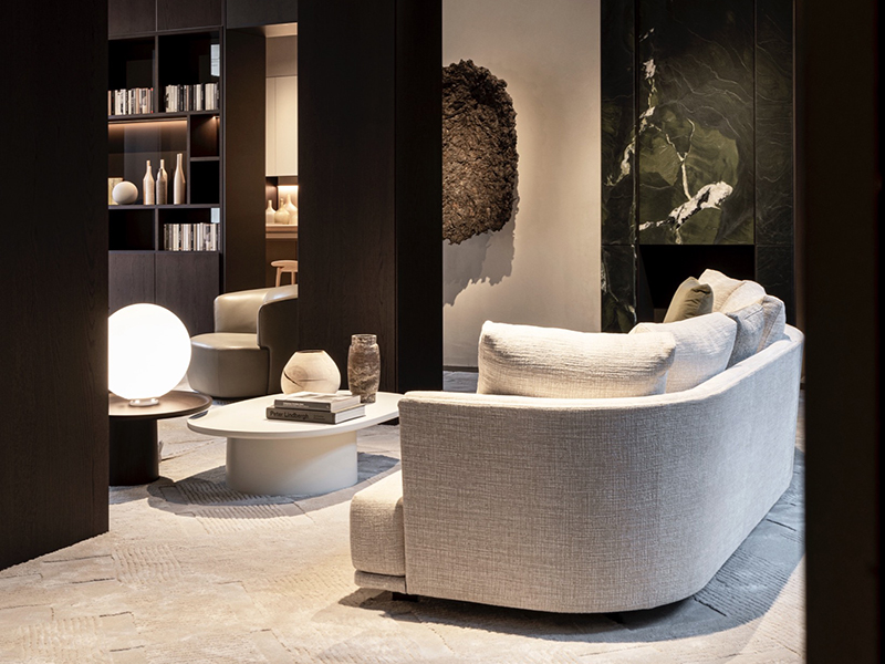 Milan showroom at Palazzo Molteni with white couch and coffee table, with black columns