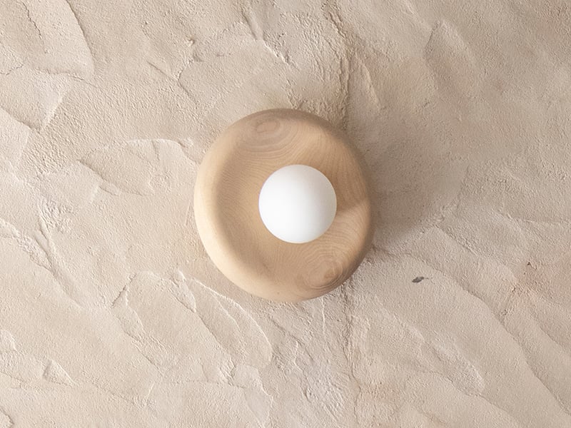Nest lamp from Origin Made against a beige background