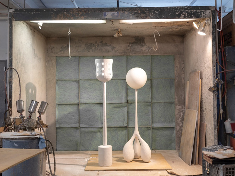 Ralph Pucci PURE exhibition - two abstract white lamps in an industrial work station
