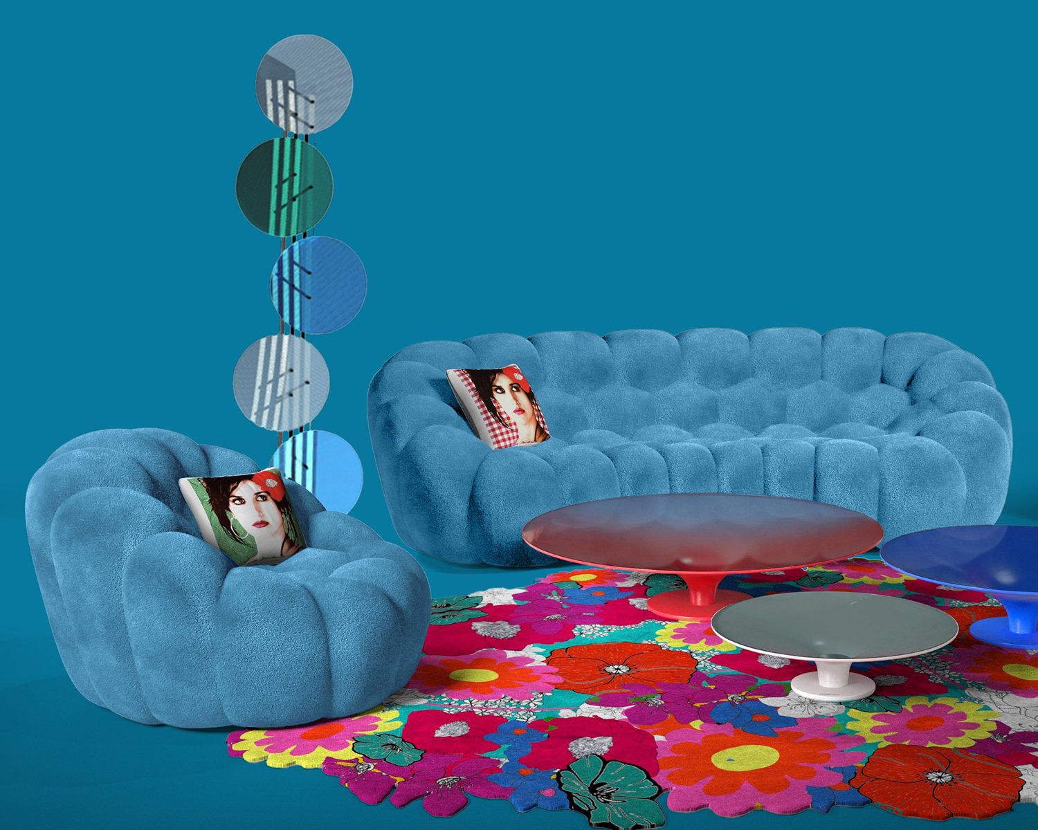 Two blue sofas and a multi-coloured flower rug
