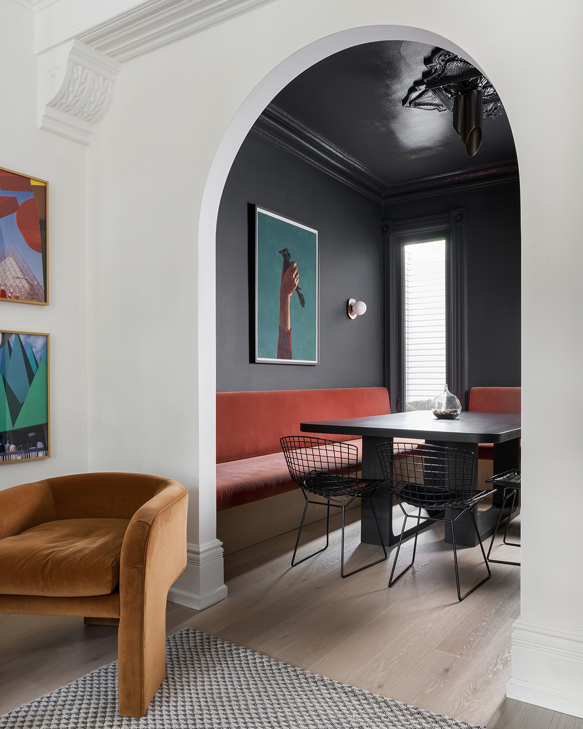 Flyt Wide wood flooring by Studio Konior with black dining table and chairs and a brown chair