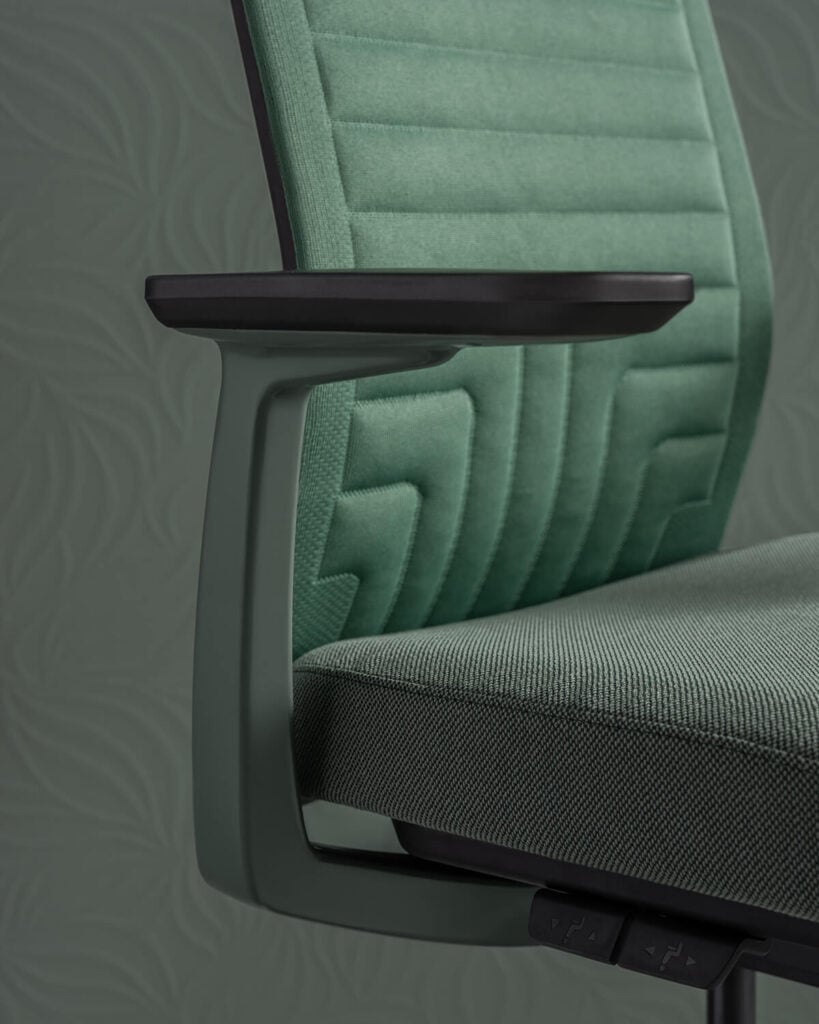 Conference chair with grey seat and green quilted back