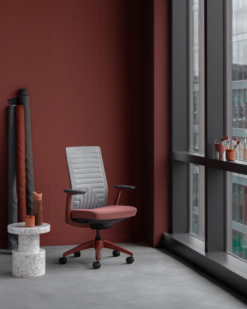 Conference chair with red seat and grey quilted back