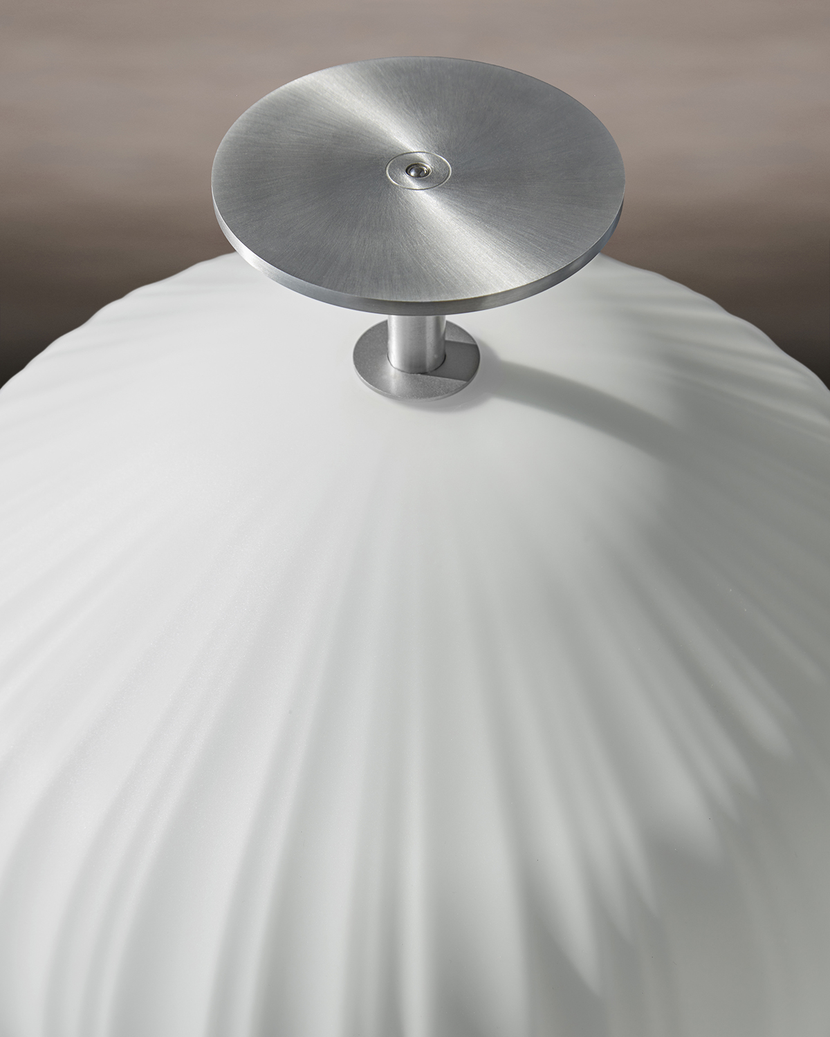 The Plissée pendant and floor lamp from ClassiCon were designed by Sebastian Herkner