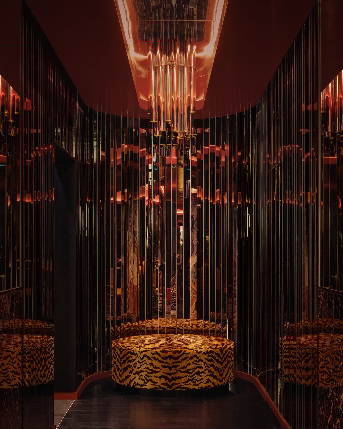 Mirrored alcove with tiger-print pouffe