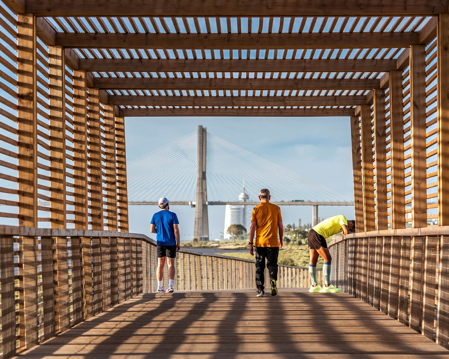 People stand in a slatted wooden tunnel