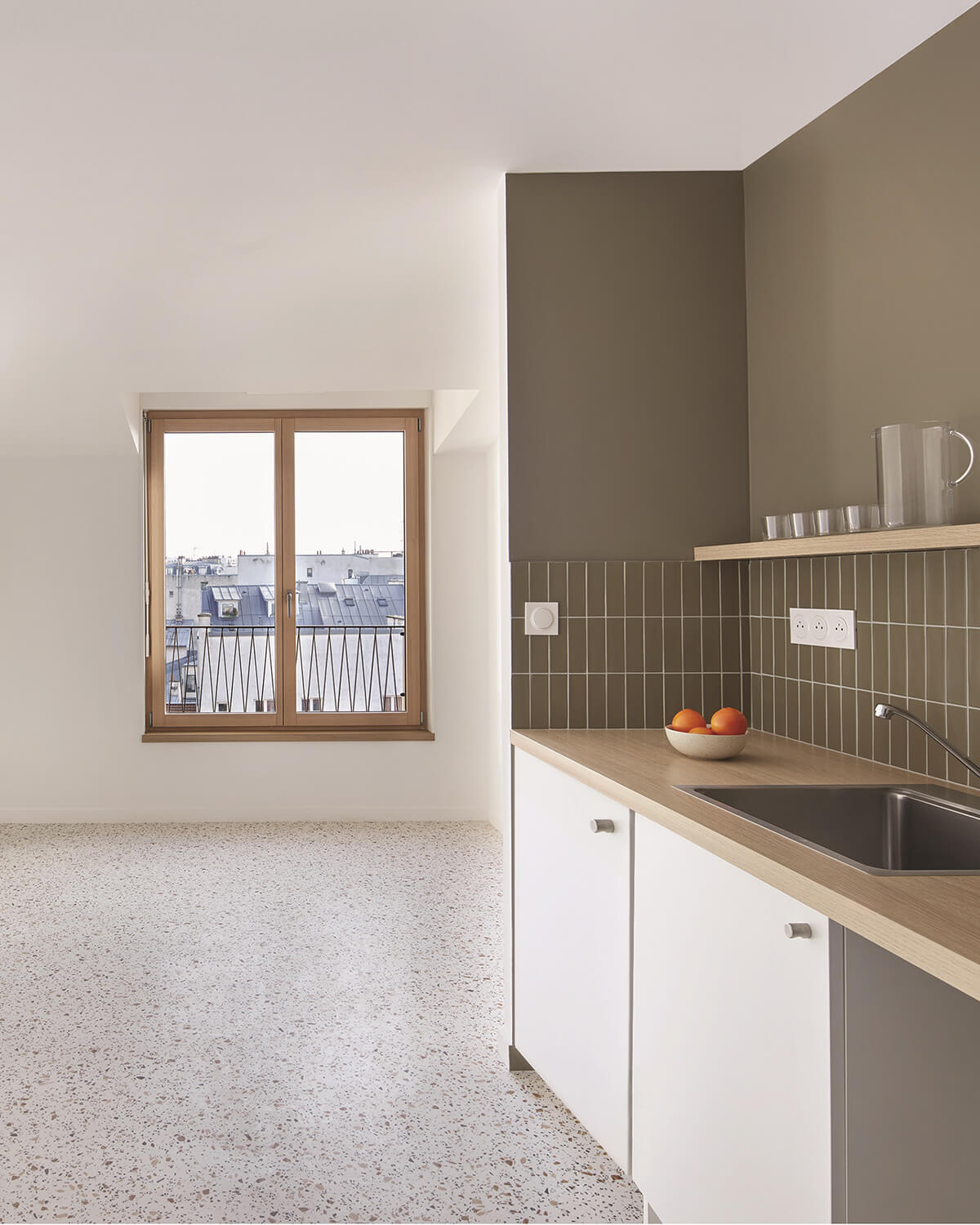 Kitchen with green tiles and white cabinets