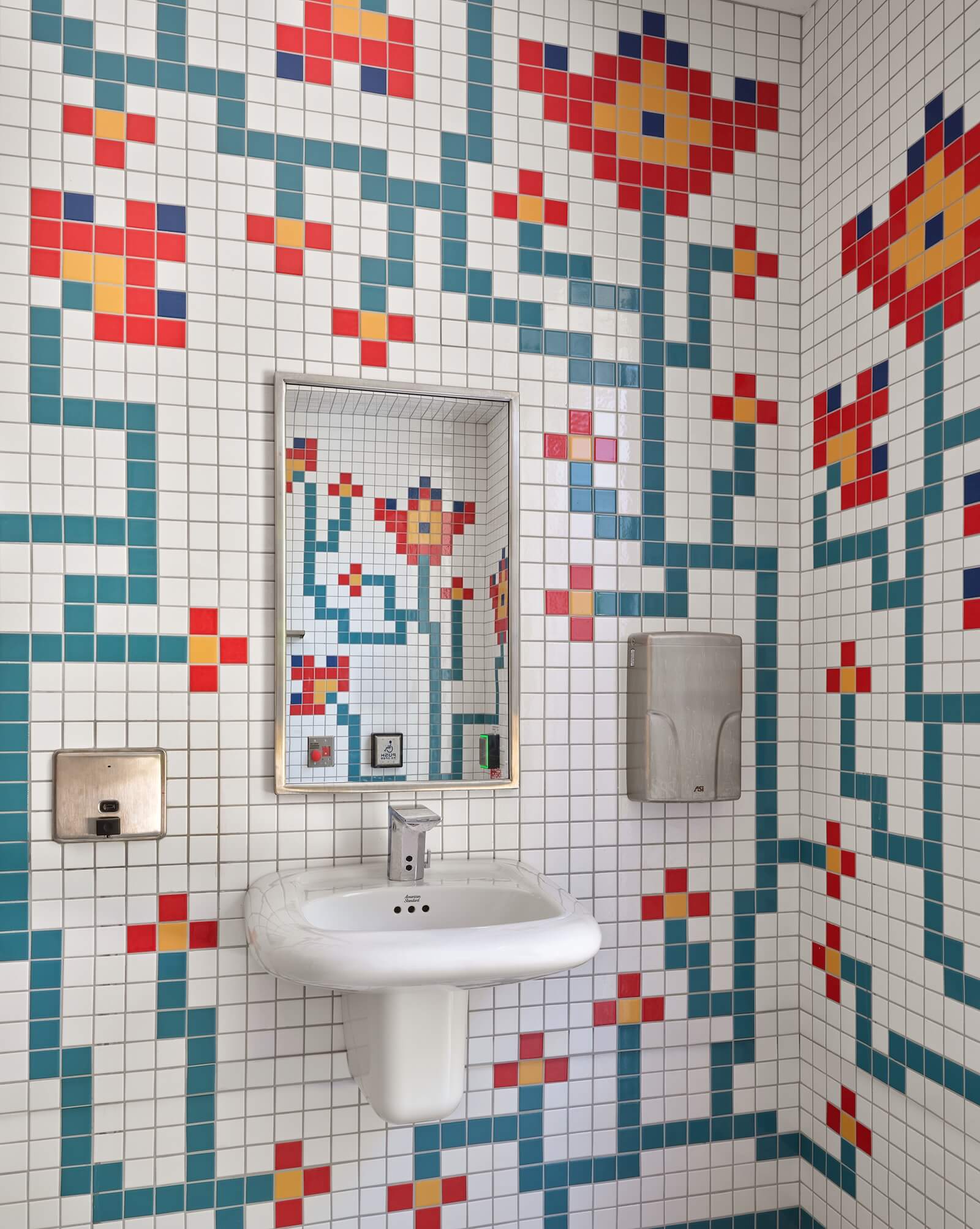 The bathroom’s tile mosaic plays up the eclectic and artistic spirit of the pavilion and its host organization.