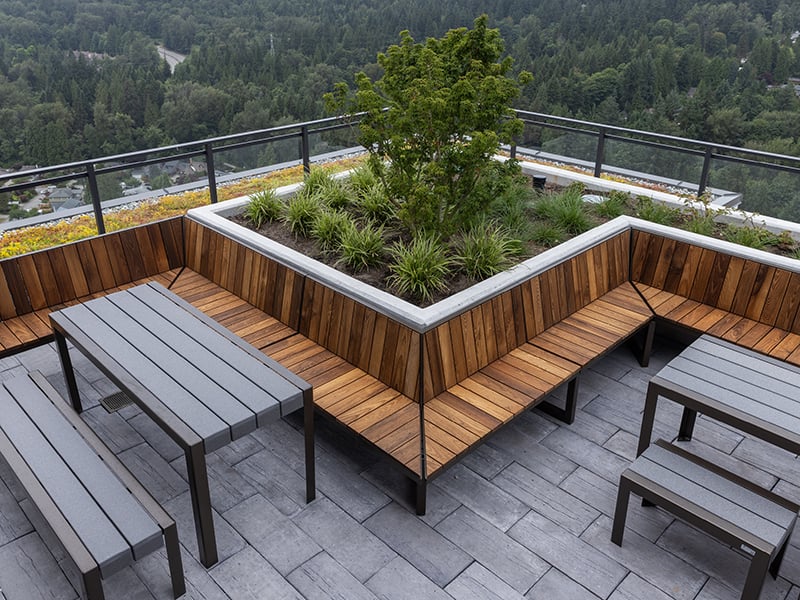 Patio with wraparound wooden bench and black dining set
