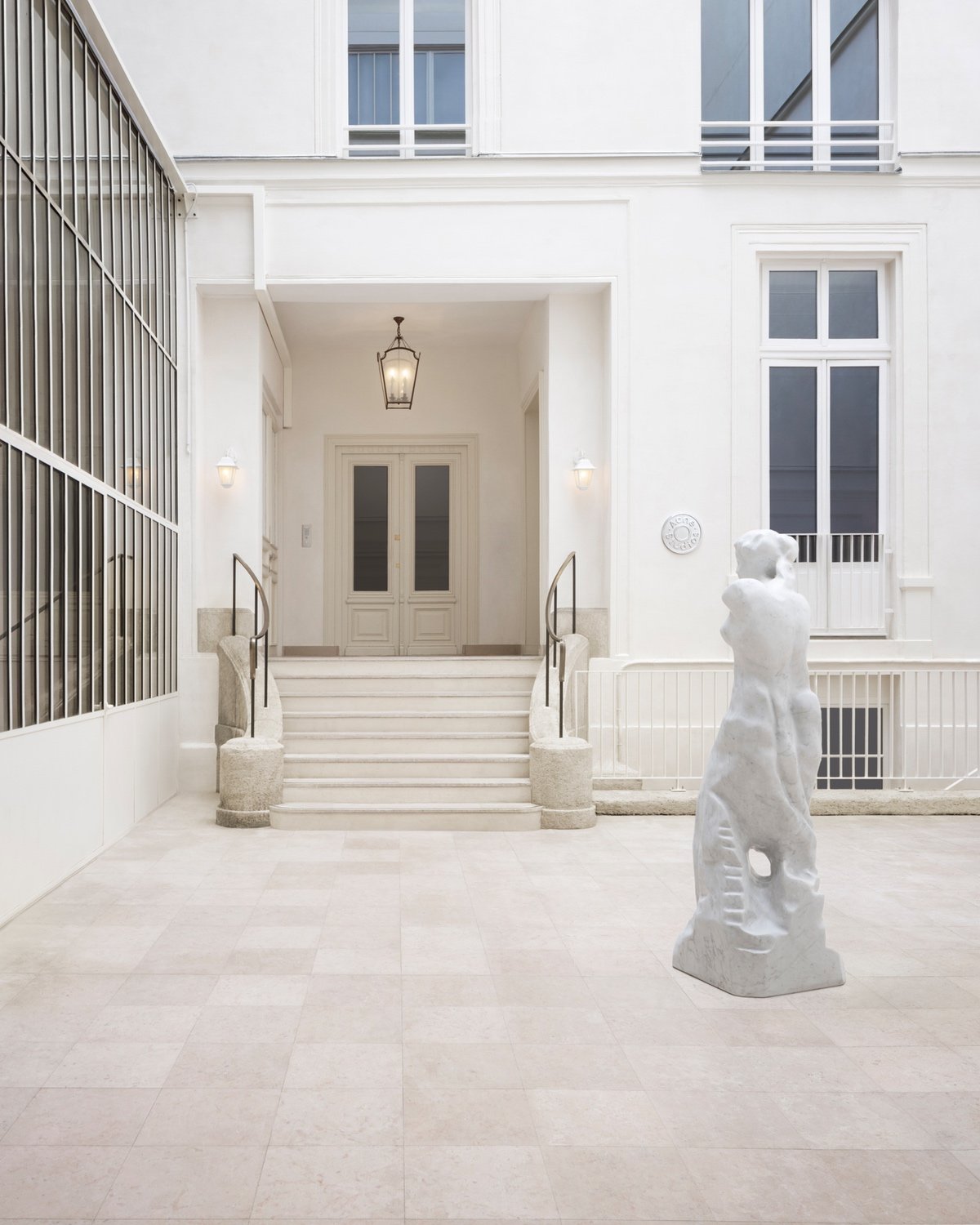 A white statue in a courtyard.
