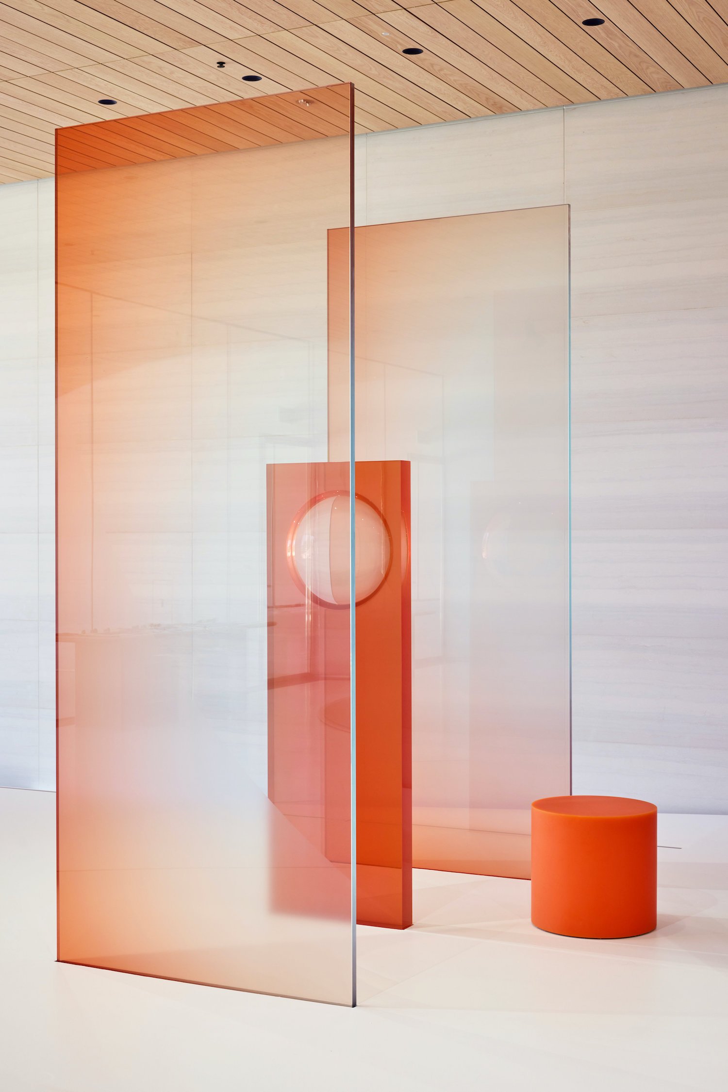A series of orange glass and resin panels designed by Sabine Marcelis and installed at Apple Park for an iPhone launch event