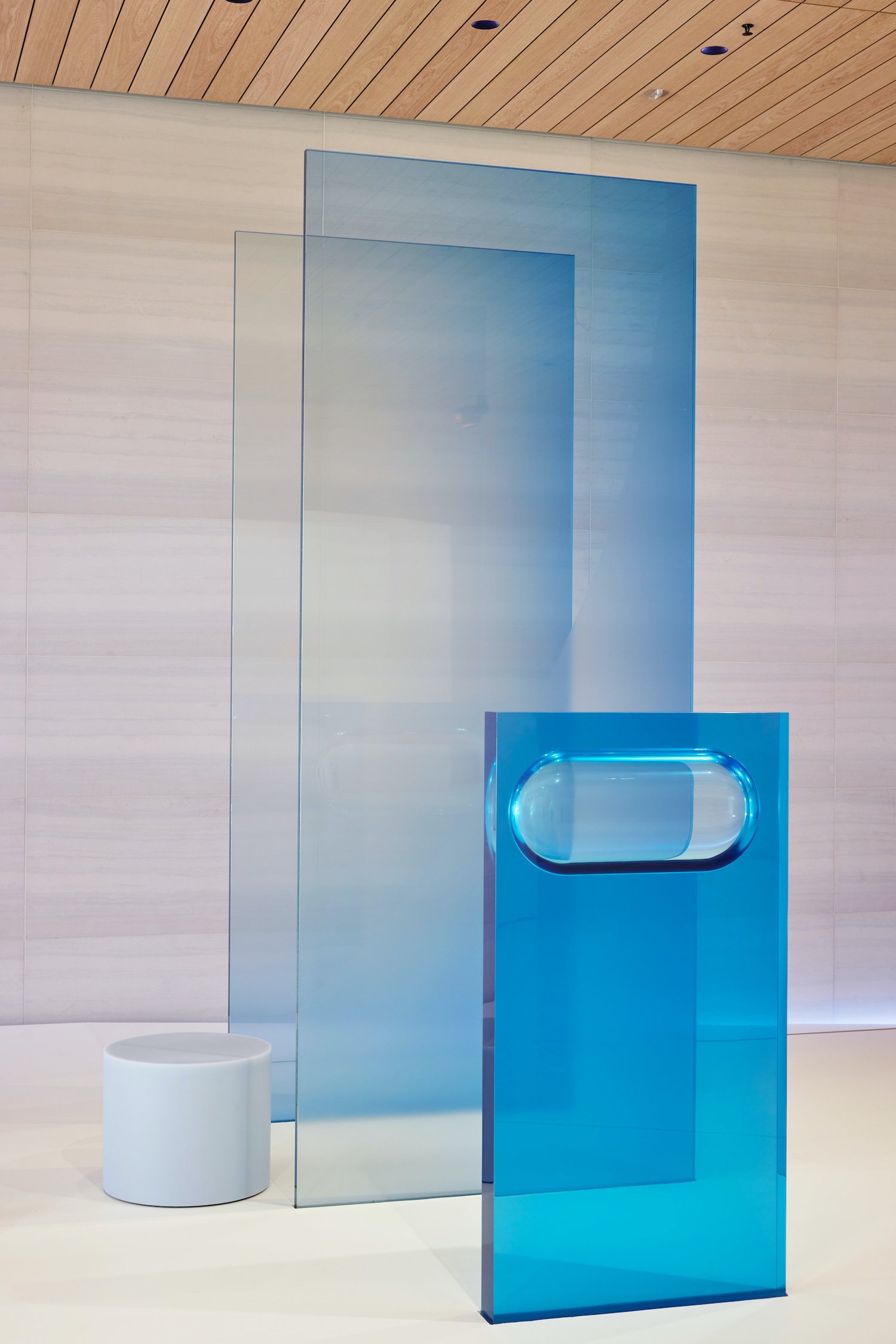 A series of blue glass and resin panels designed by Sabine Marcelis and installed at Apple Park for an iPhone launch event