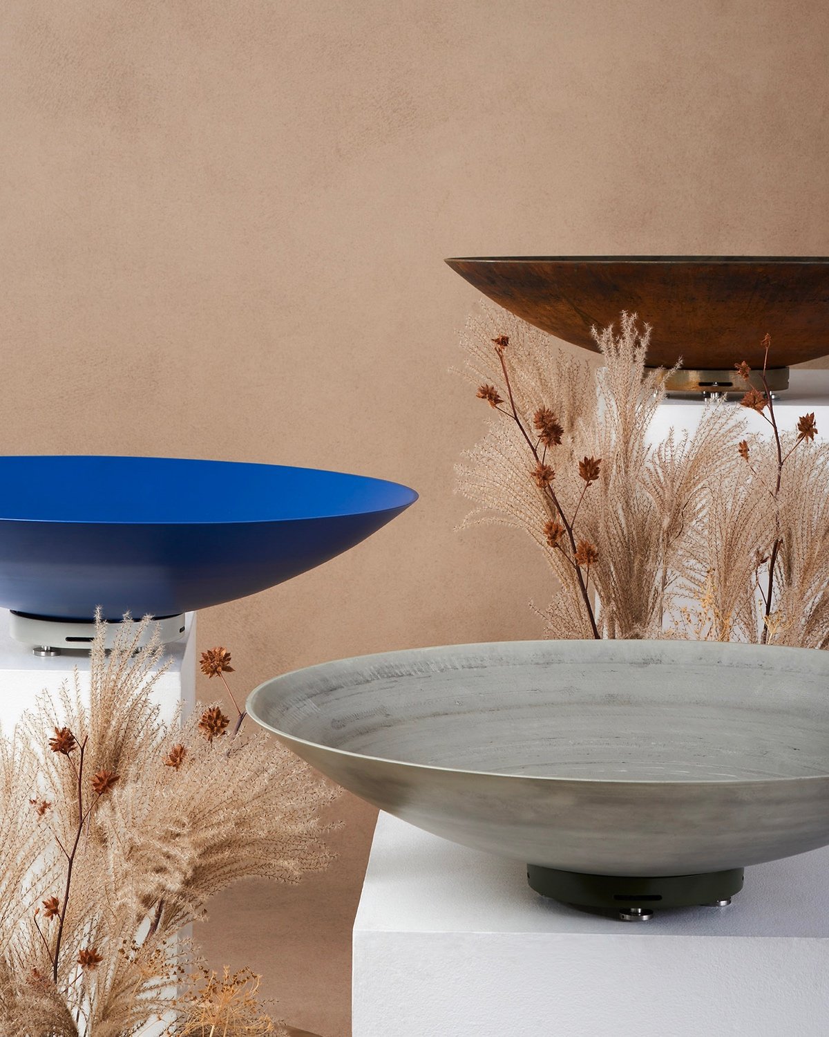 A trio of shallow Été planters by landscape architect Kate Fox-Whyte in a series of different finishes: Corten steel, blue powder-coated aluminum and satin aluminum.