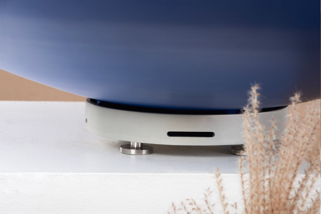 A blue planter resting on a satin aluminum tray with adjustable feet.