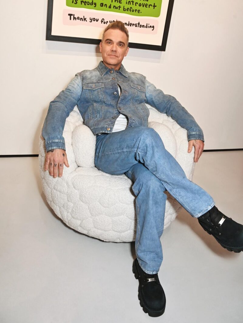 Robbie Williams sits in the Introvert chair he designed for Moooi