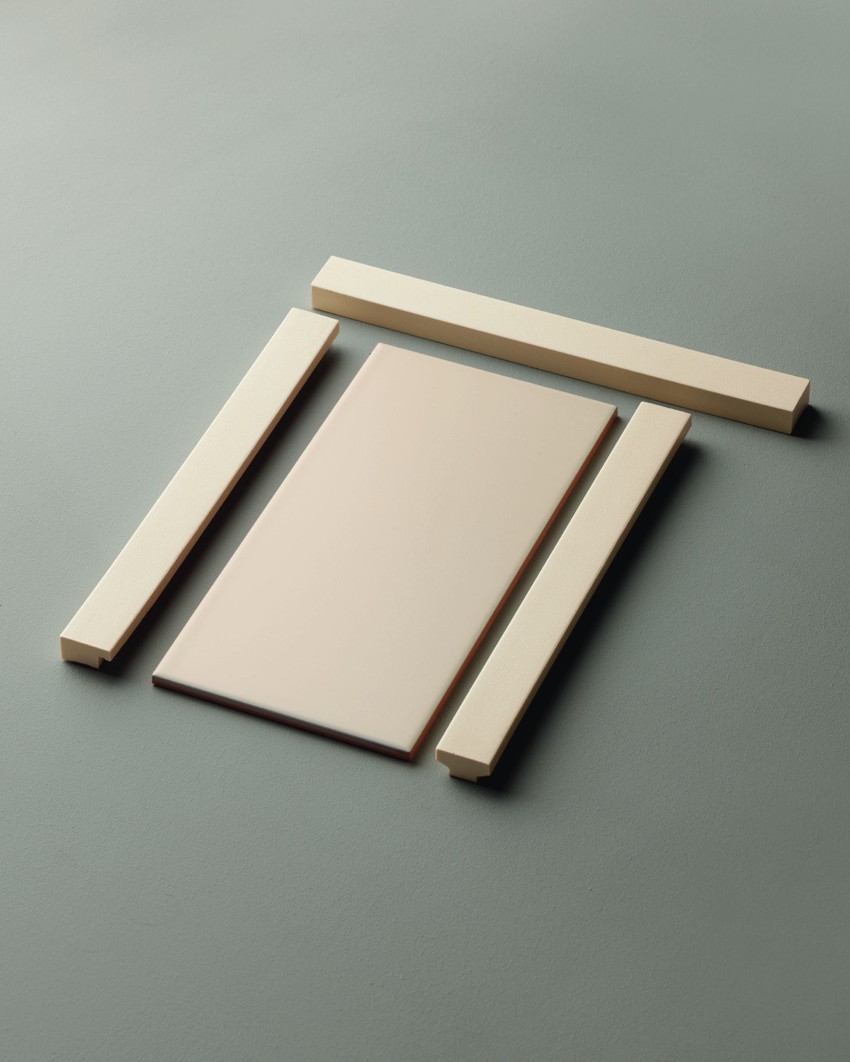 Rectangular beige tiles on green-grey background