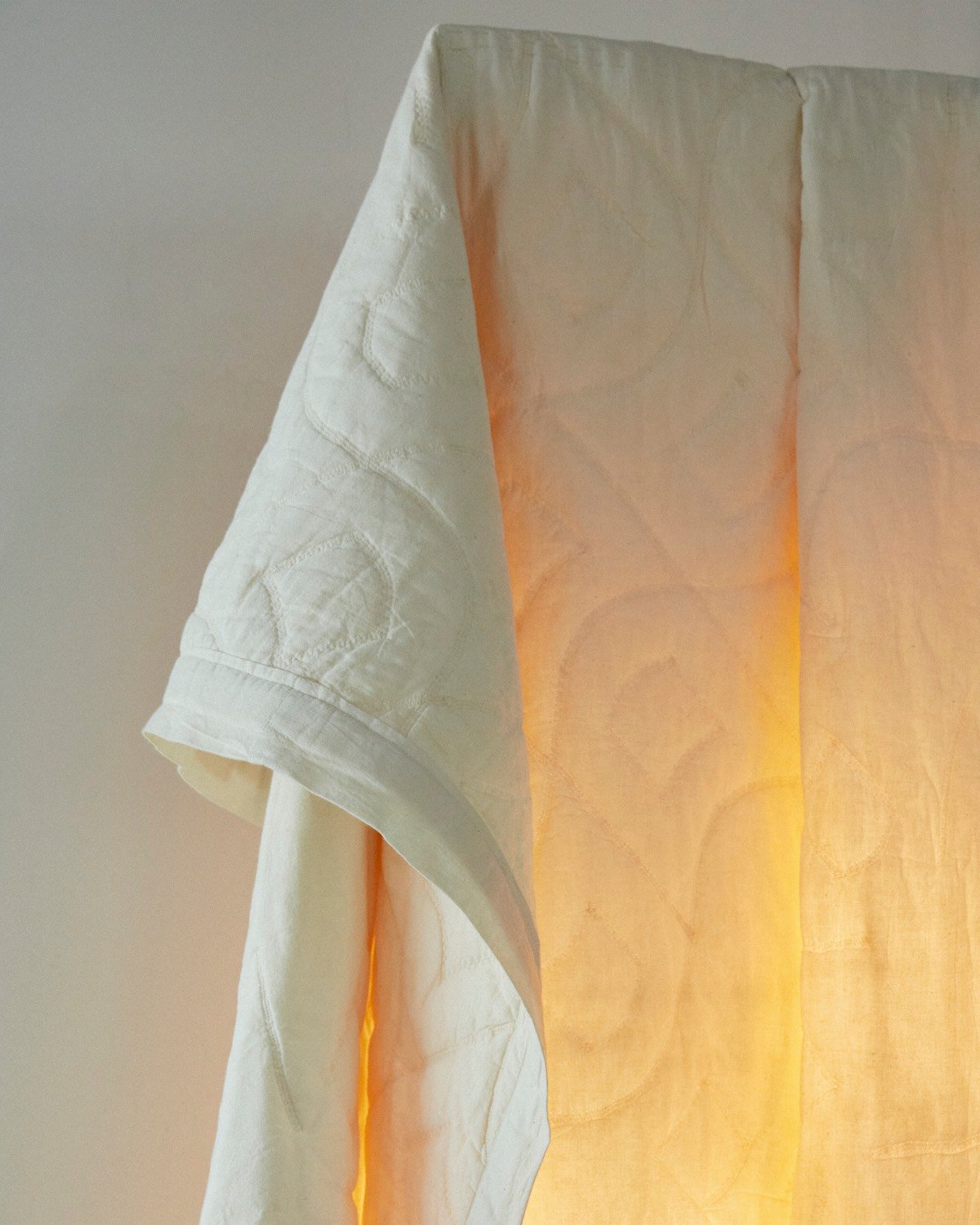 Quilt lighting by White Dirt is made with a draped cotton blanket that is hand-stitched