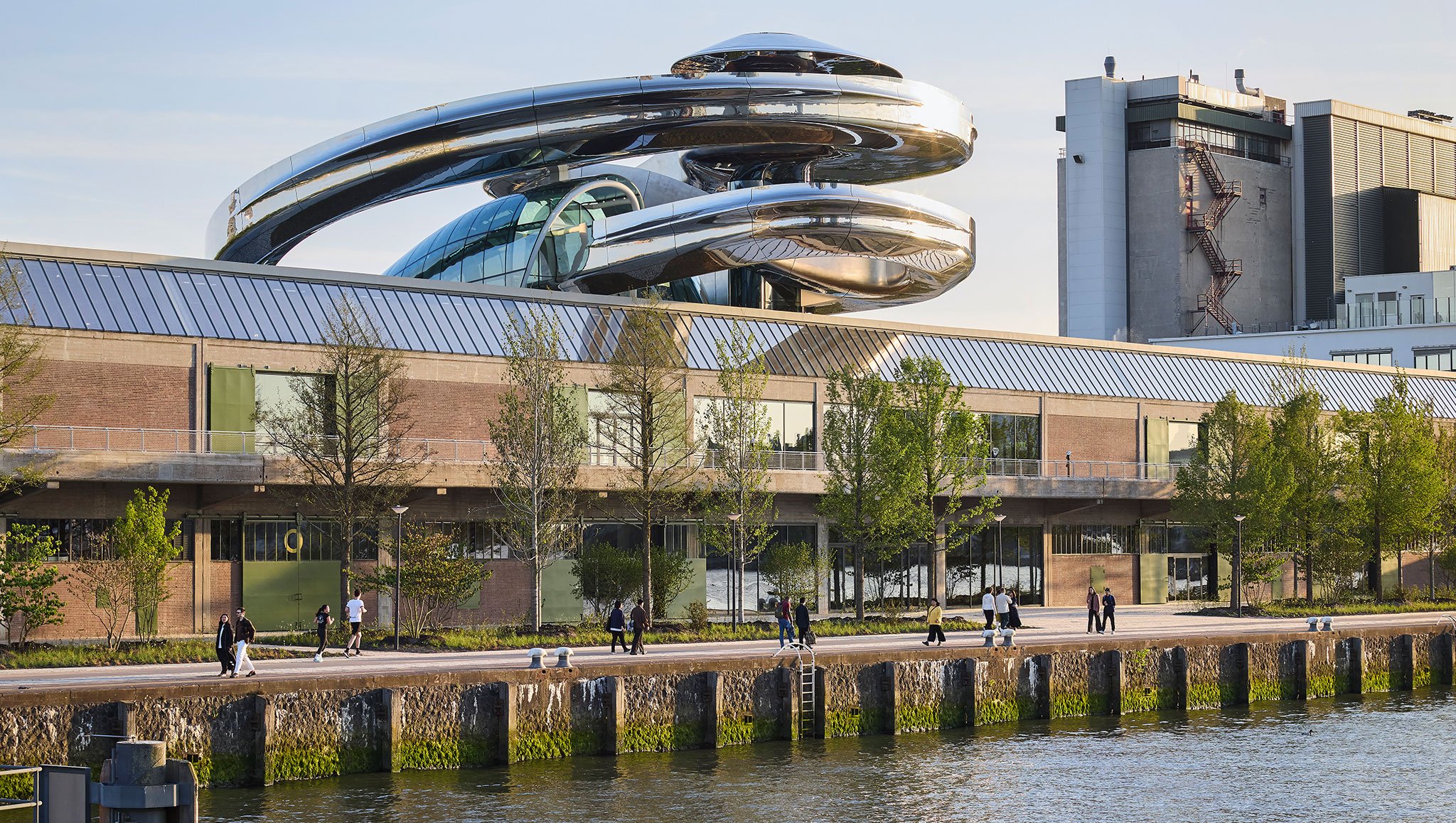 A spiral metallic staircase on top of a long warehouse building at the Fenix Museum of Migration, one of the top architecture projects of 2025.