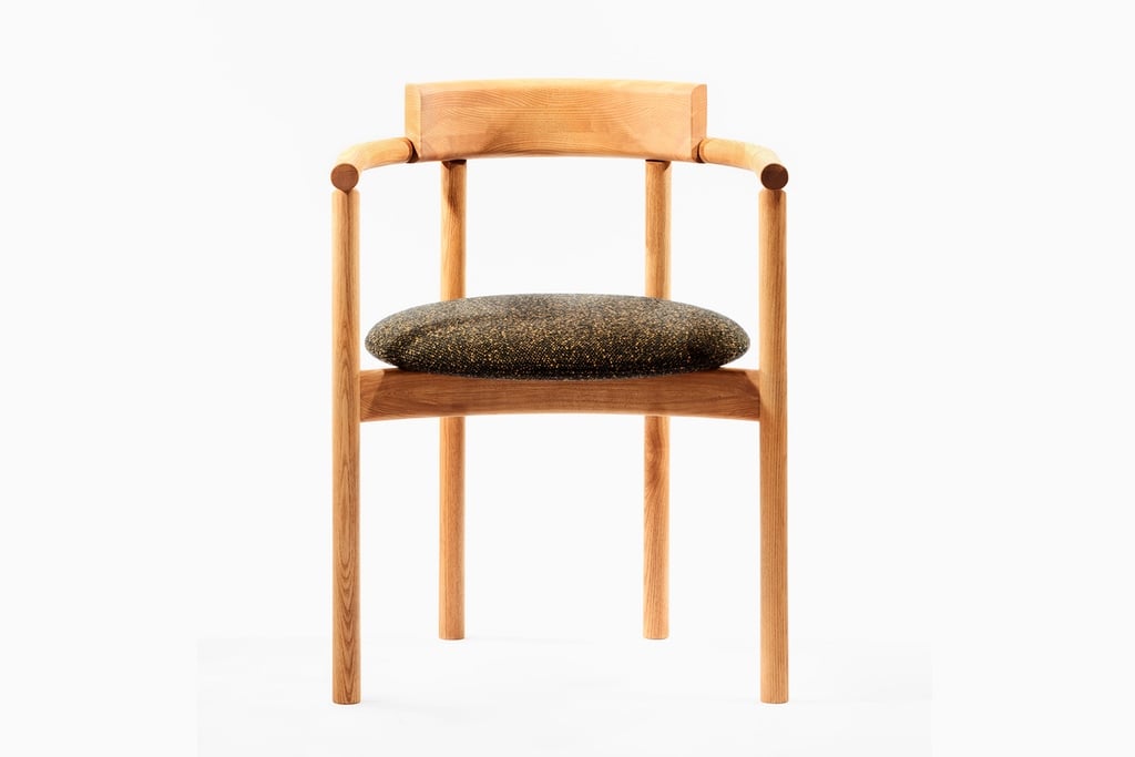 A wooden dining chair with a circular seat cushion.