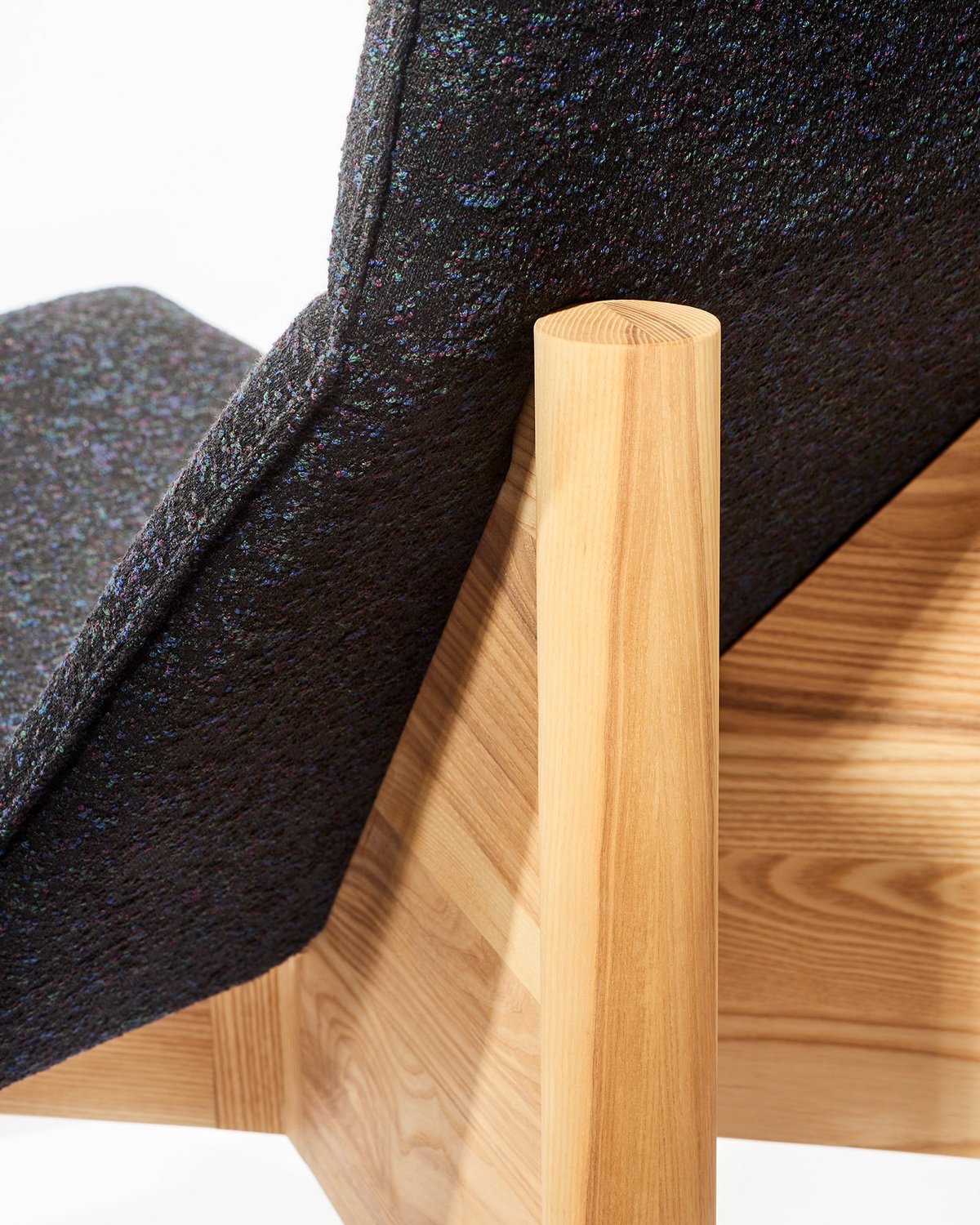 A closeup of the wooden frame on a lounge chair from the modern Canadian furniture brand Ourse.