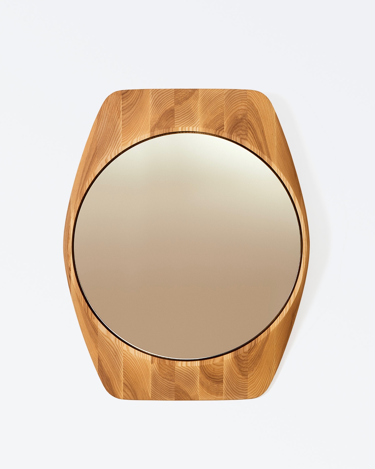 A modern rounded wall mirror from the Canadian furniture brand Ourse.