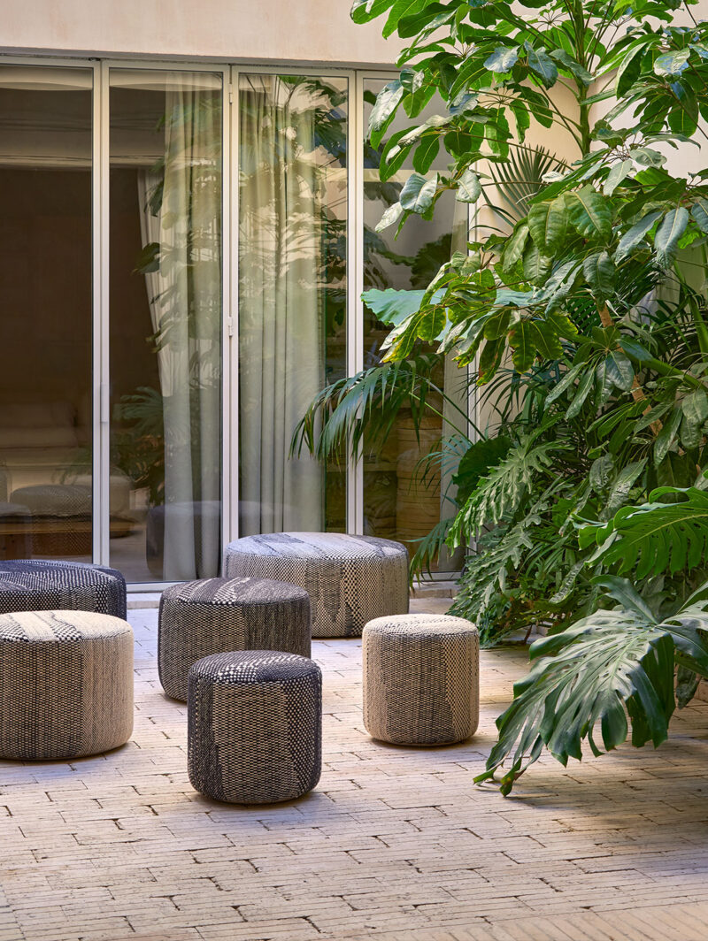 A group of textured grey and beige pouffes launched at Feria Habitat 2025 in Valencia, shown in a variety of sizes=