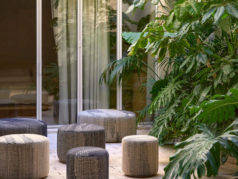 A group of textured grey and beige pouffes launched at Feria Habitat 2025 in Valencia, shown in a variety of sizes=