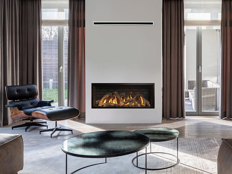 Living room with sofa, arc lamp, Eames lounge chair and fireplace