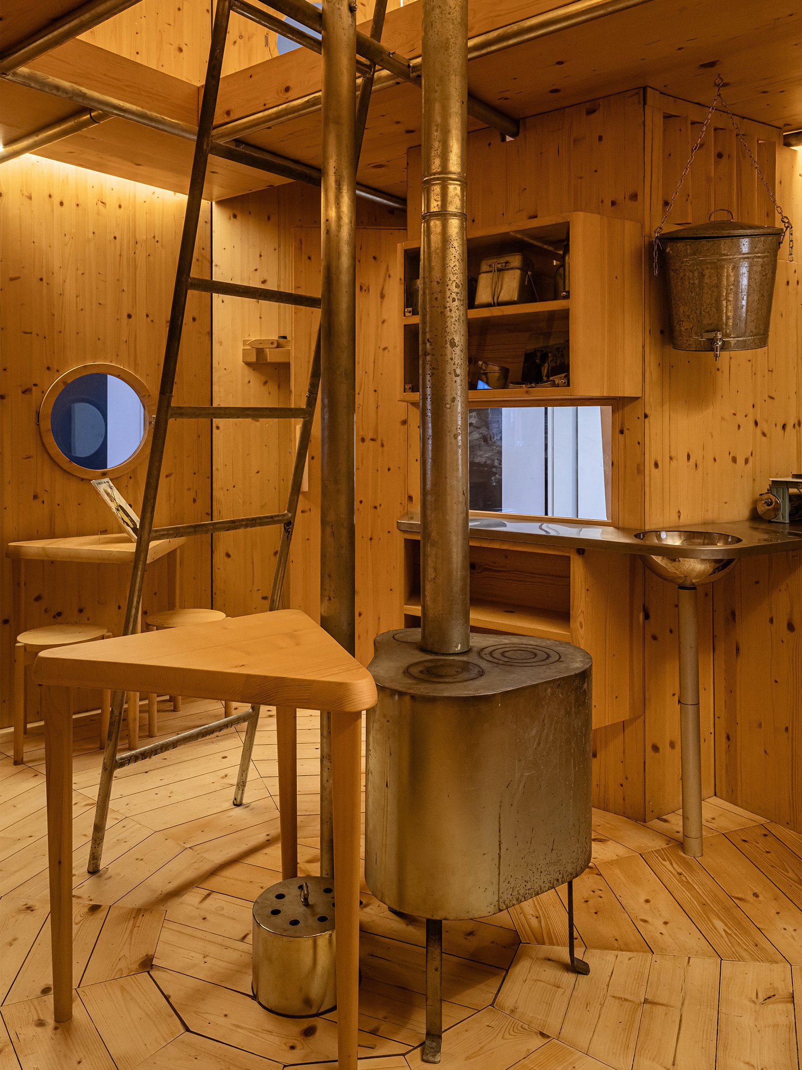 A view of the wooden inside of Refuge Tonneau mountain shelter by Charlotte Perriand and Pierre Jeanneret at White Out a Triennale exhibition about winter sports.