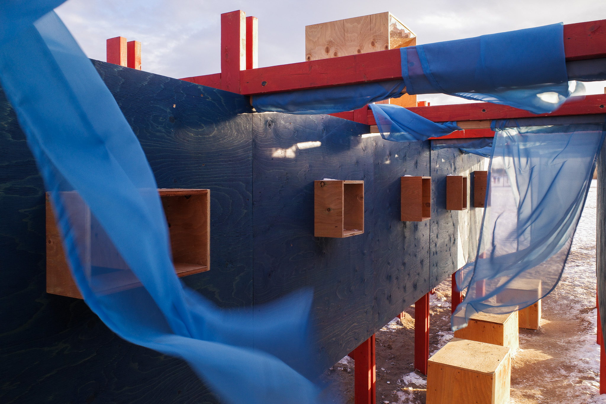 A closeup of the wood-framed apertures inside of one of the pavilions in Toronto's Winter Stations 2026 exhibition.