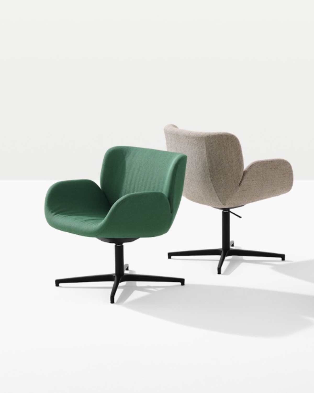 Two modern swivel chairs with armrests are shown on a white background; one is green and the other is light beige, both with black metal bases.