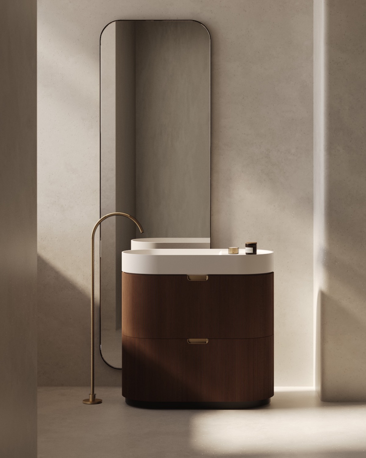 A modern Mono bathroom vanity by Falper with a curved wooden cabinet, white basin, brass faucet, and a tall rectangular mirror against a beige wall.