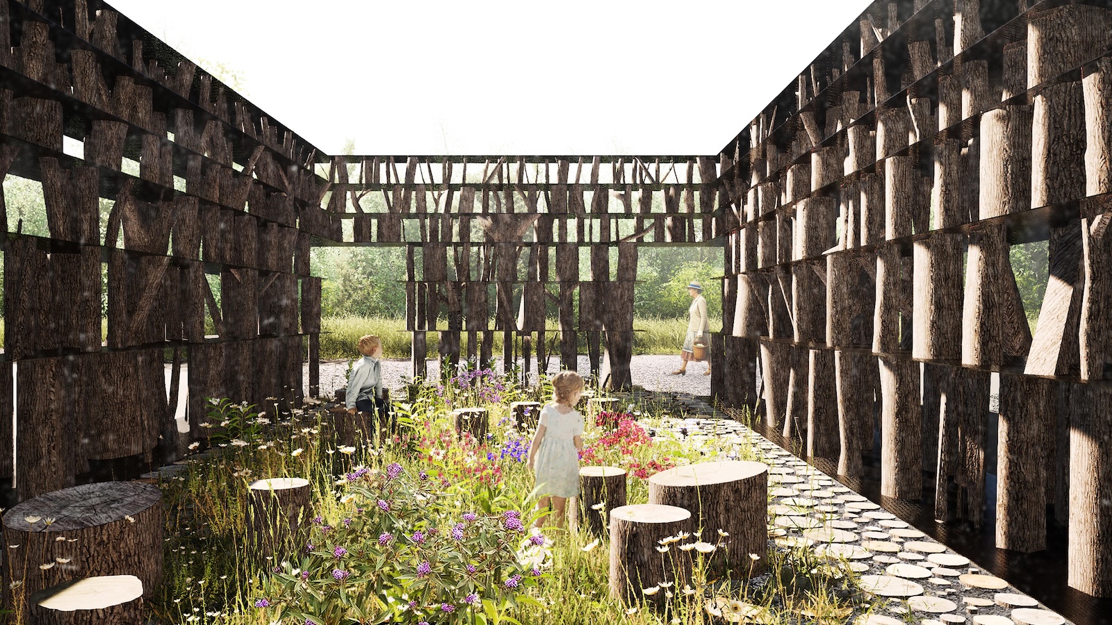 Children and an adult stand inside an open-roofed structure made of cut tree trunks, surrounded by wildflowers and greenery, with log stools on a pebble floor.