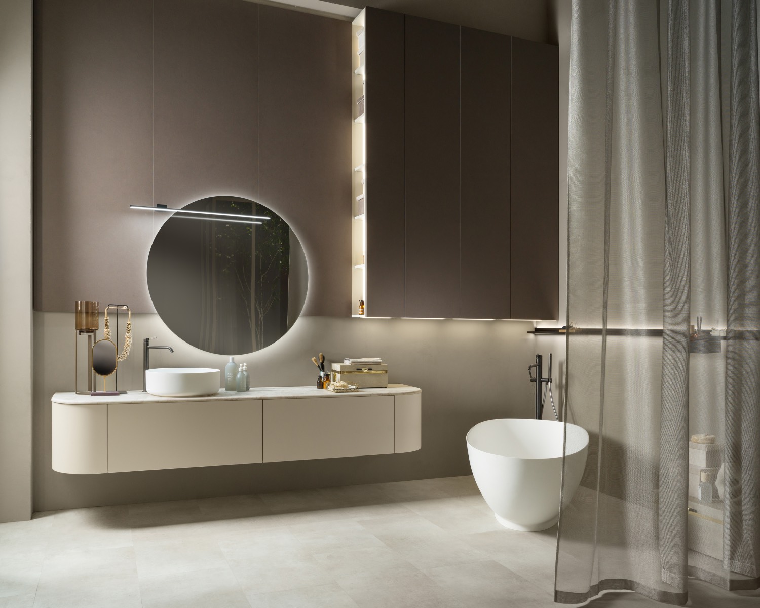 Modern bathroom with a Flair vanity from Scavolini, featuring a round mirror, vessel sink, freestanding bathtub, tall cabinets, and sheer curtains.