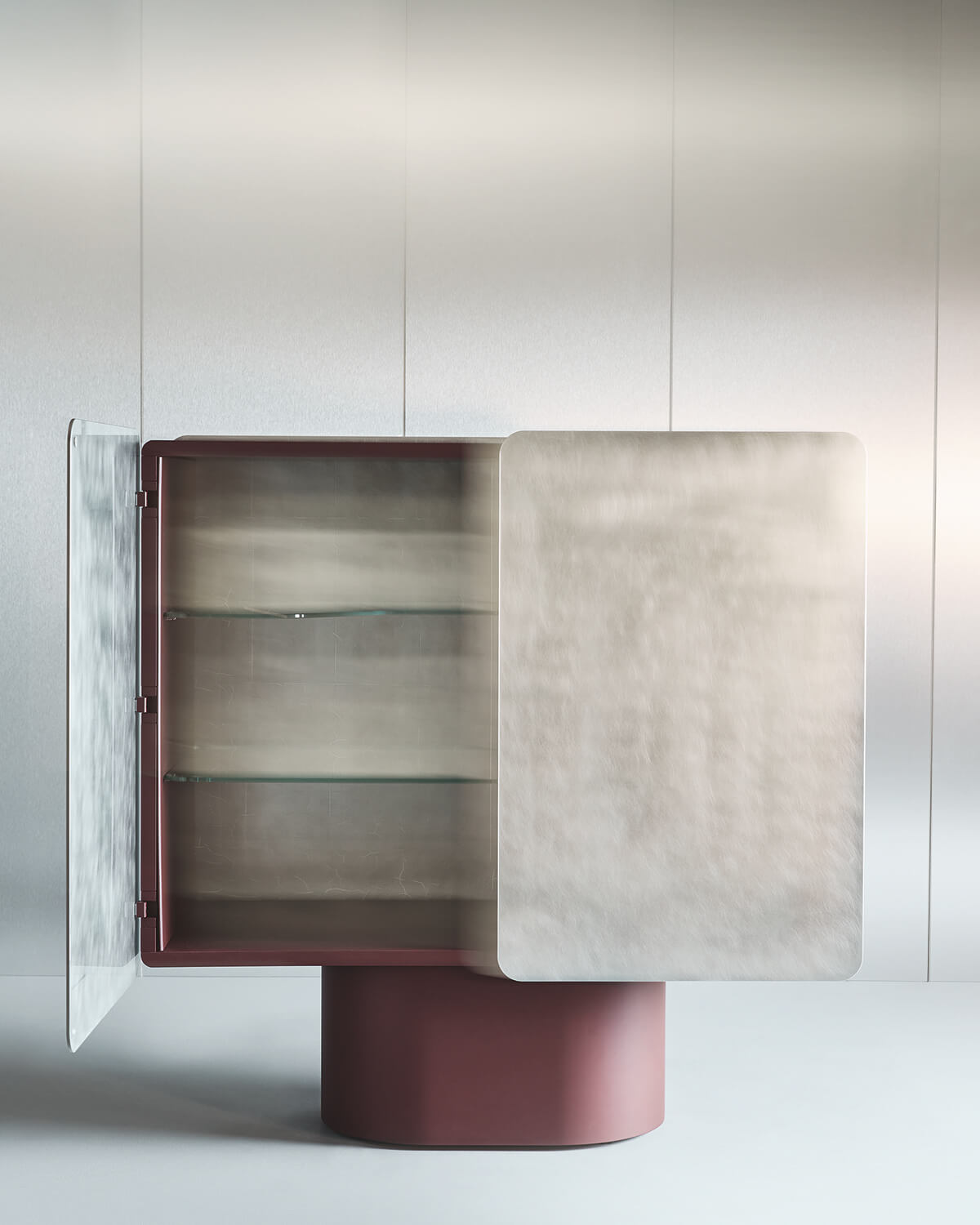 A modern cabinet with a red base and brushed metal doors, one opened to reveal two glass shelves inside, standing against a plain light wall.