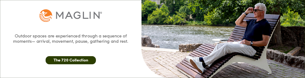 A man sits and relaxes on a modern wooden outdoor lounge chair from the 720 Collection by Maglin, wearing sunglasses and casual clothing, with trees and water in the background.