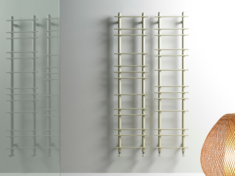 Two tall, light-colored wall-mounted towel radiators featuring horizontal bars at varying intervals.